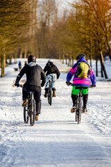 Cyclists ride on the bike path in the city Park