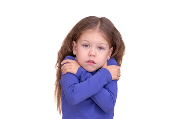 Freezing child kid feeling cold holding crossed arms because of coldness, isolated on white background looking at camera waist up caucasian little girl of 5 years in blue