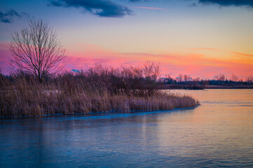 Calming view of a colorful sunset on a frozen lake.