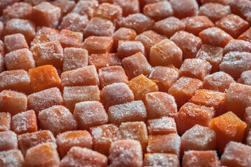 Frozen fresh carrot cube pieces closeup background