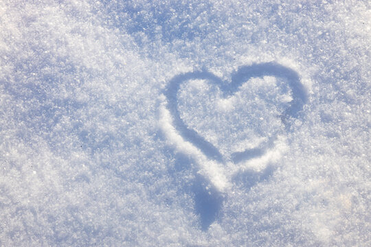 Heart made in snow. Abstract backgorund for winter. Winter love concept. High quality photo