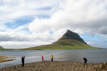 Icelandic mountain with kids playing by the water