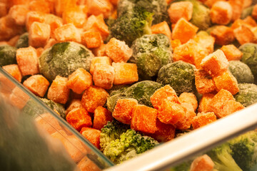 frozen carrots, broccoli florets, brussel sprouts inside freezer container