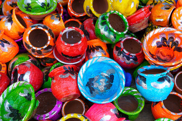 Handicrafts made from clay painted in colorful shapes in the form of kitchen utensils. These toys are widely sold in Indonesia on the roadside during traditional events or festivals.