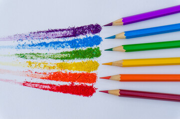 several colored pencils together with watercolor