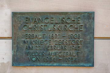 Close-up view of the memorial wall plaque at the Christuskirche (Christ Church) in Mainz, Germany. A reminder of the built between 1897 and 1903, and the reconstruction between 1951 and 1954.
