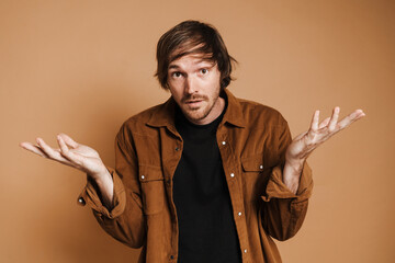 White unshaven man looking and gesturing at camera