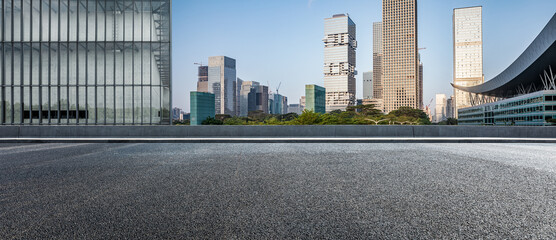 Asphalt road and city skyline with modern commercial office buildings in Shenzhen, China.