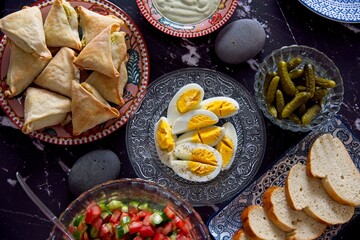 A healthy Mediterranean diet. Israeli breakfast. Vegetable salad, eggs, pickles, bread. Flat lay. High quality photo