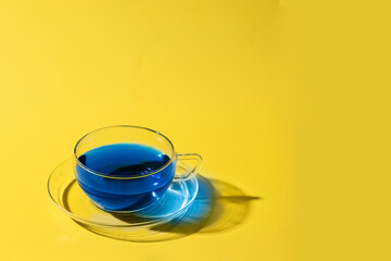 Butterfly pea flower  or blue tea cup on yellow background. Ayurvedic herbal beverage for rejuvenates the skin  and anti-aging effect