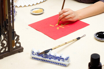 chinese calligraphy Master writing new year golden character Fu means Blessing, Good Fortune, Luck