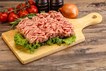 Raw pork minced meat over board