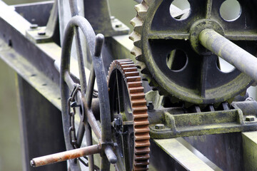 The detail of an old cogwheel gearing. Shabby and rusty, as it was not used for a long time. 