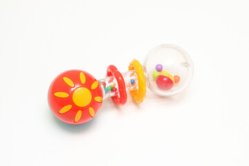 The childs toy, the colorful rattle isolated in a white background. Also a tool to learn handling and grow the skills. 