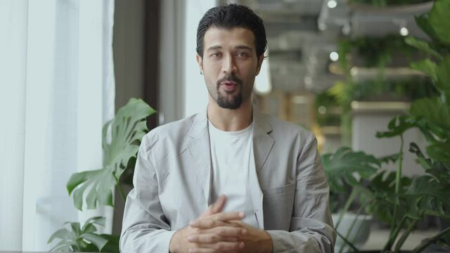 latin businessman looking at camera making video call talking to customer online service . hispanic male video conference to meeting online . e-learning or  teaching online .