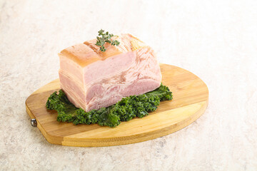 Cut of pork bacon over board