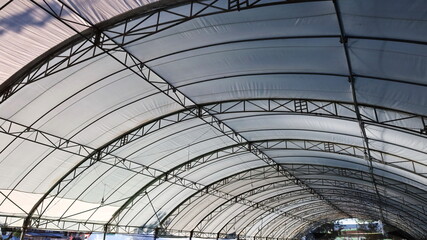 Metal structure with white tent roof. Large tents to prepare for outdoor festivals or fairs. selective focus