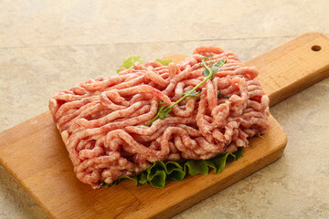 Raw minced pork meat over board