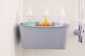 Non-brand soaps and shampoos available in the shower of a vacation rental.