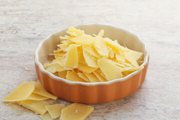 Sliced parmesan cheese heap in the bowl