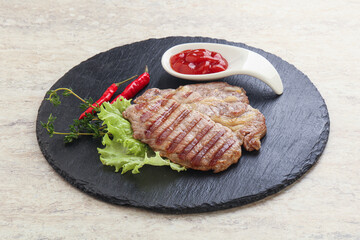Grilled pork neck steak with ketchup