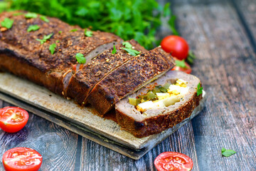 Home made baked  delicious  German meatloaf (Falscher Hase or Hackbraten) is a traditional pork and beef meat loaf bound with boiled eggs and cucumbers