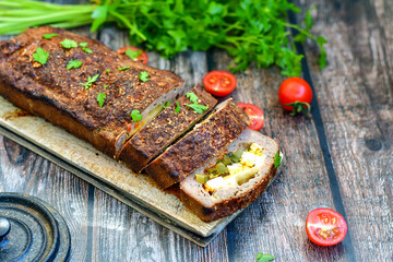 Home made baked  delicious  German meatloaf (Falscher Hase or Hackbraten) is a traditional pork and beef meat loaf bound with boiled eggs and cucumbers