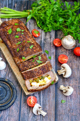 Home made baked  delicious  German meatloaf (Falscher Hase or Hackbraten) is a traditional pork and beef meat loaf bound with boiled eggs and cucumbers