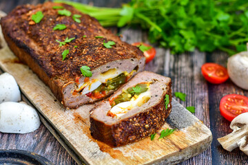 Home made baked  delicious  German meatloaf (Falscher Hase or Hackbraten) is a traditional pork and beef meat loaf bound with boiled eggs and cucumbers