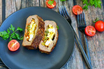 Home made baked  delicious  German meatloaf (Falscher Hase or Hackbraten) is a traditional pork and beef meat loaf bound with boiled eggs and cucumbers