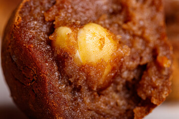 Beautiful candy truffle with a nut inside on a white plate on a black background