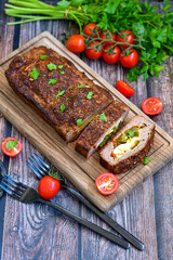 Home made baked  delicious  German meatloaf (Falscher Hase or Hackbraten) is a traditional pork and beef meat loaf bound with boiled eggs and cucumbers