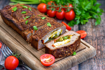 Home made baked  delicious  German meatloaf (Falscher Hase or Hackbraten) is a traditional pork and beef meat loaf bound with boiled eggs and cucumbers