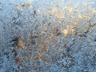 Winter frozen window covered with ice crystals