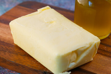 slice of a butter on a paper on table 
