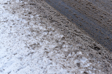 Winter. Part of the road with dirty snow