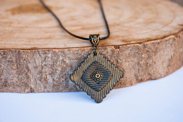 Black and gold geometric pendant of polymer clay. Handmade jewelry.