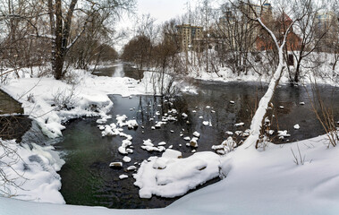 snow-covered river in winter snow