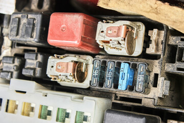 Repair of the fuse box of the car engine by improvised means. Urgent repair of faulty fuses with a coin. The theme of cars, auto repair shops, repair.