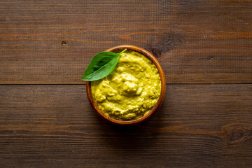 Green guacamole avocado dip in bowl, top view