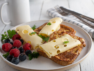 French toast with cheese and berries on a plate for breakfast