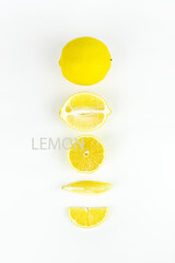 A set of sliced lemon on white background. Flat lay, top view, vertical.