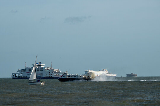 hovercraft brittany ferry and wightlink ferry passing a fort in The Solent England