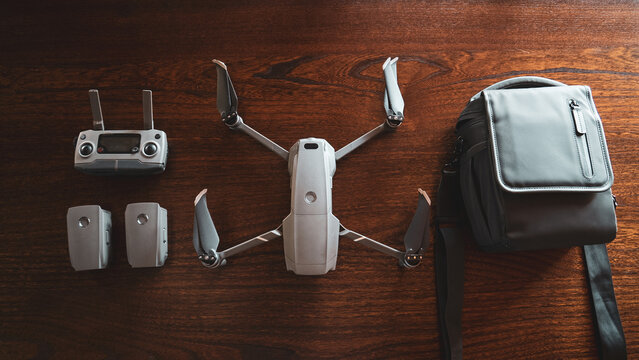 Top Shot of a drone and components, wooden background.