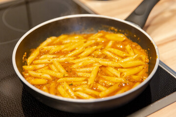 penne pasta with bolognese sauce in a pan