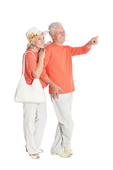 Portrait of happy senior couple pointing to the right isolated on white background