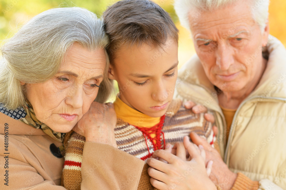 Sticker portrait of sad grandfather, grandmother and grandson hugging