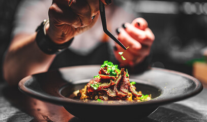 Chef decorate plate with food on kitchen