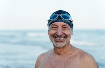 Close-up of a happy older swimmer looking at the camera.