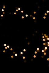 Abstract orange and gold dark background with glowing turquoise particles.